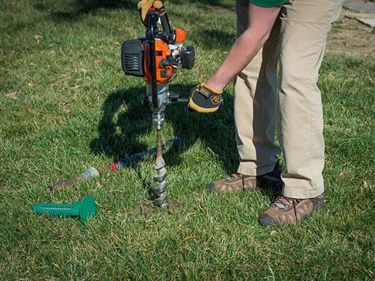 http://A%20person%20drilling%20into%20a%20yard